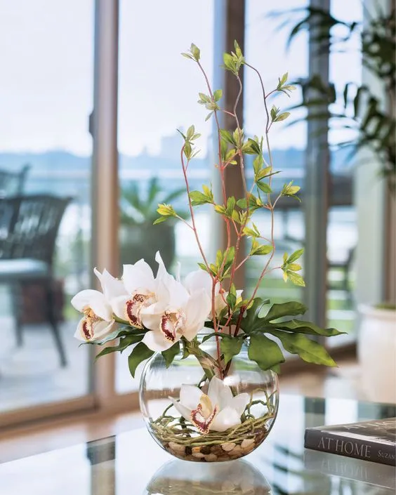 beautiful flowers, paced in a glass planter, beautiful living room