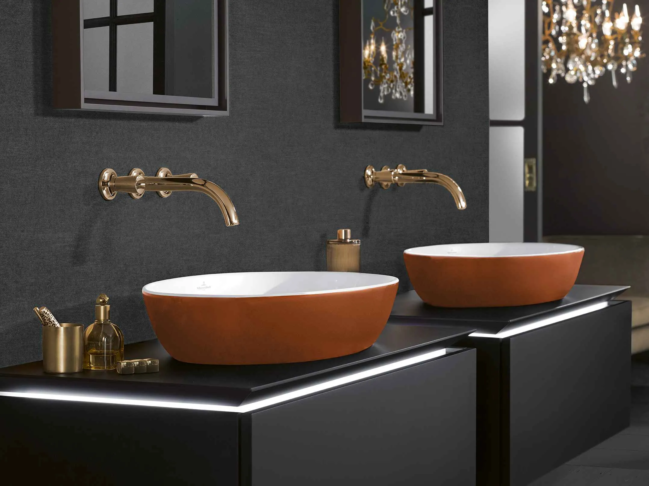 black bathroom with orange sinks and mirrors