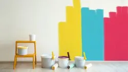 Painting the walls with yellow, blue, and pink.