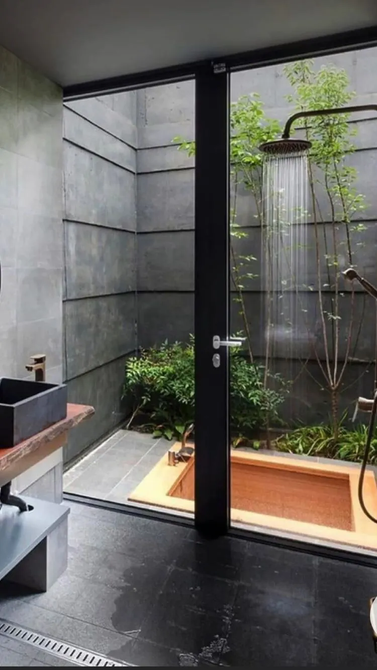 black shower with plants and a sink