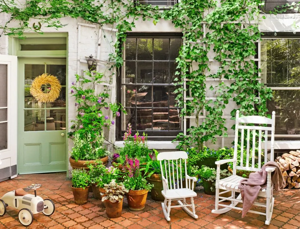 beautiful home garden with two white garden chairs and a toy car