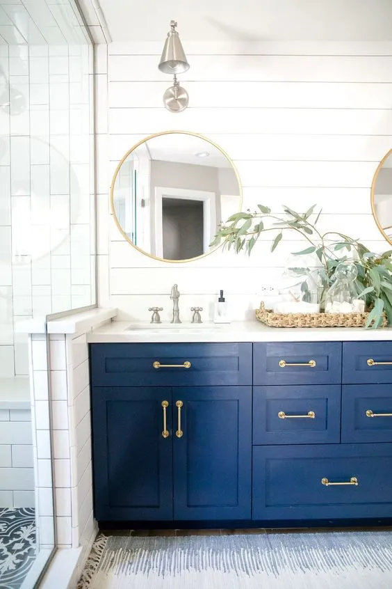 matching hardware finishes, bathroom decor, mirror, white tiles, wall sconces