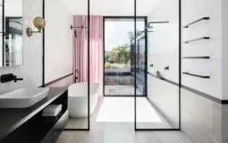 modern and minimalistic bathroom design with sliding glass doors, bathtub, and matte black bathroom fittings and accessories