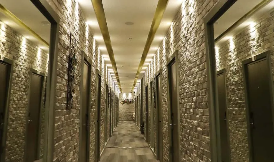 Olive and white coloured hallway ceiling.