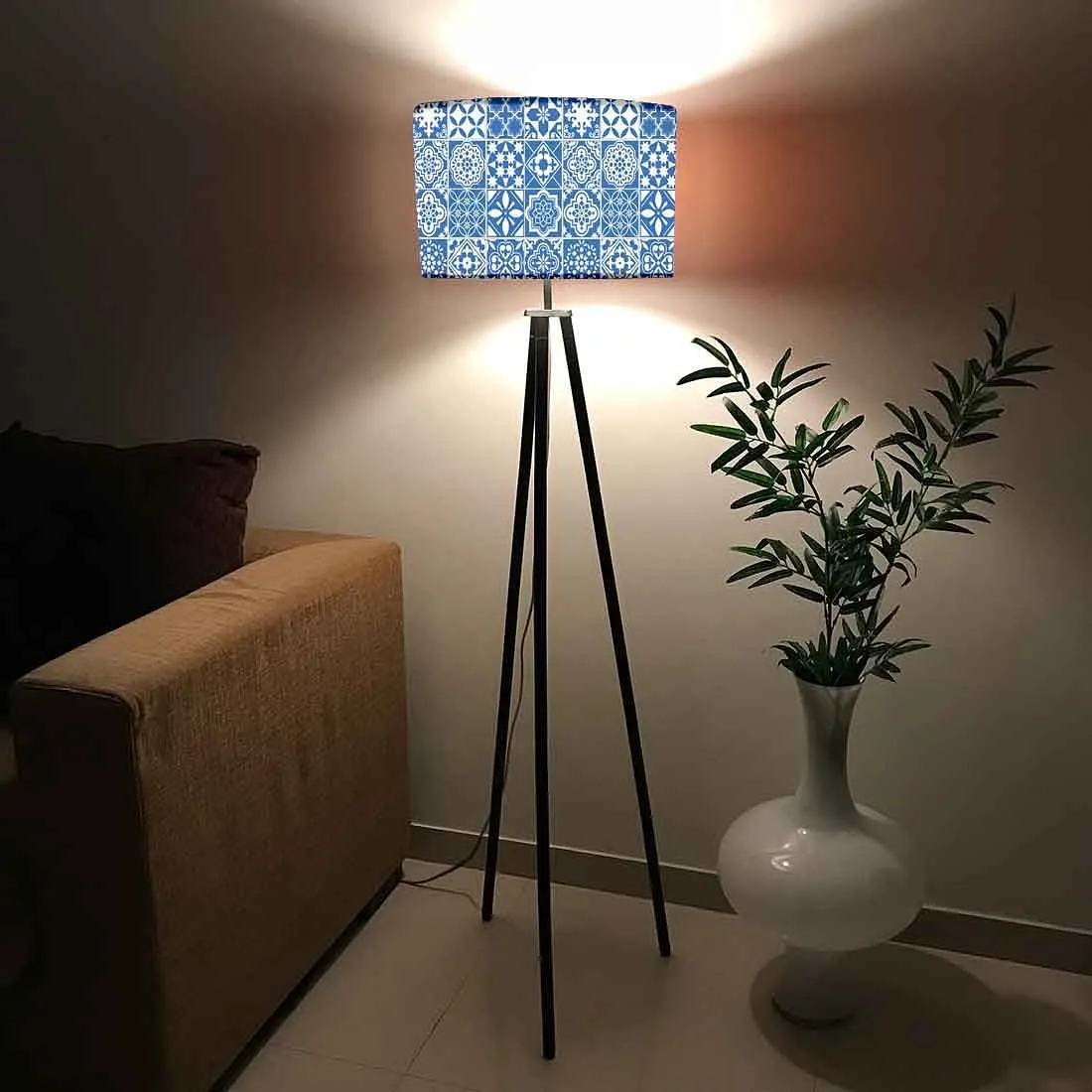 tripod uplighters floor lamps adding a touch of colour and design to your ،me, available online, indoor planter placed besides it, sofa placed in living room