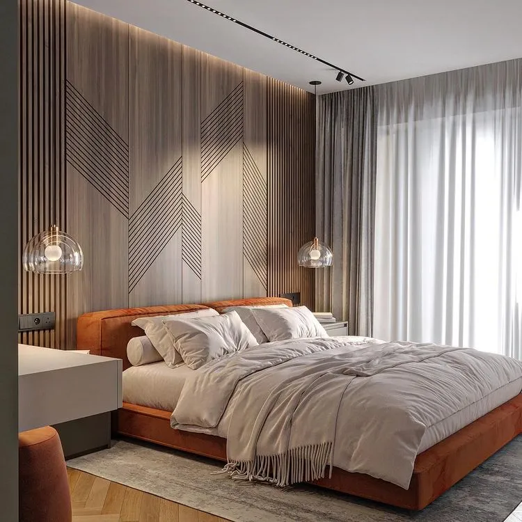 grey bedroom with a white bed, grey rug, hanging lights and brown wooden floors