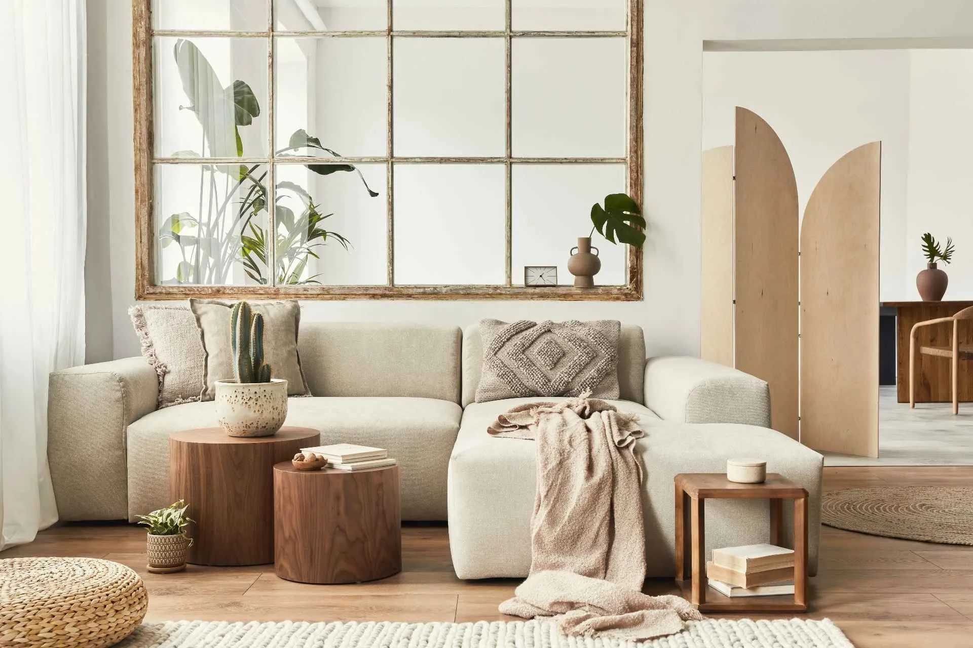 white living room combination design with brown wooden floors, white sofa, table, and plants