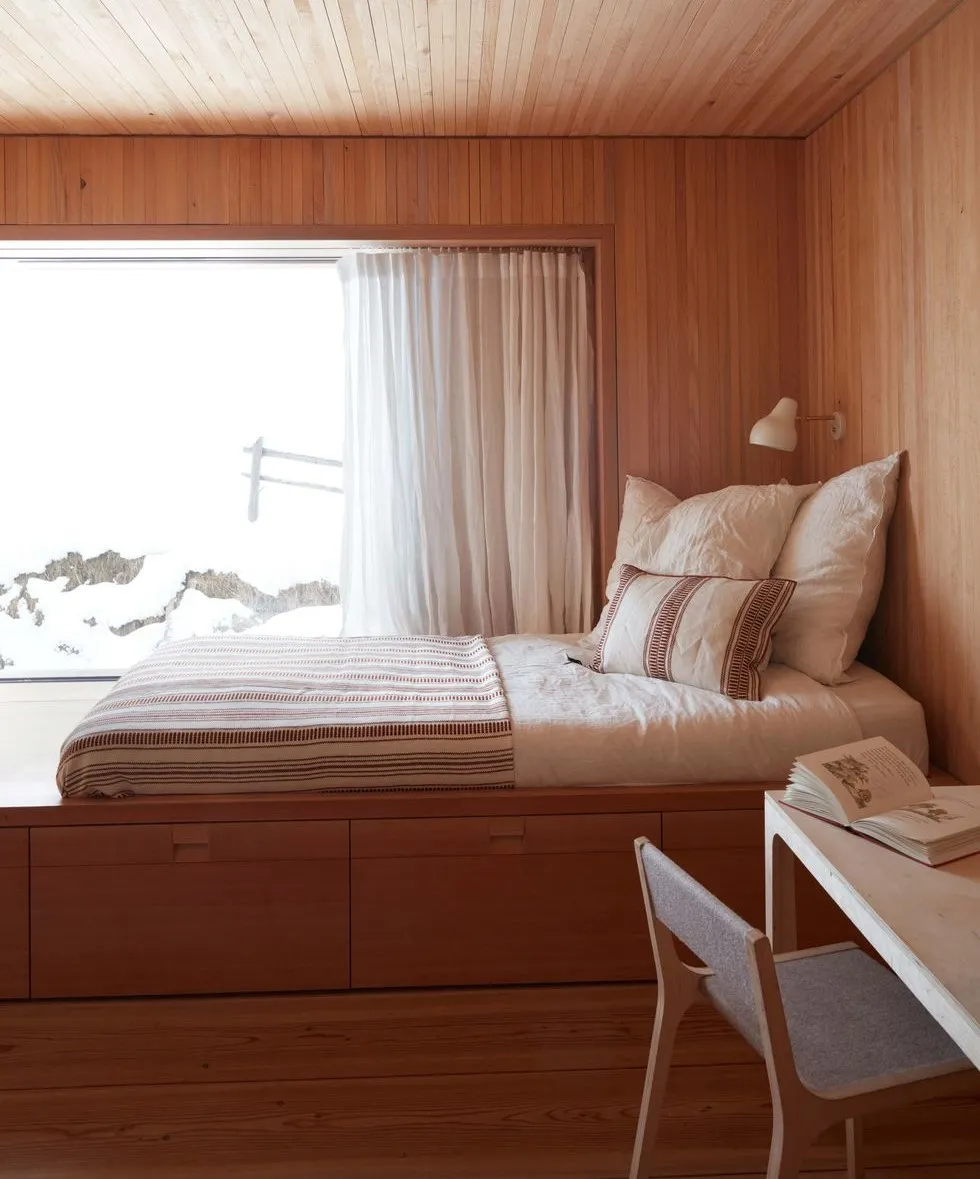 brown wooden simple bedroom design with a modern bed, table and chair