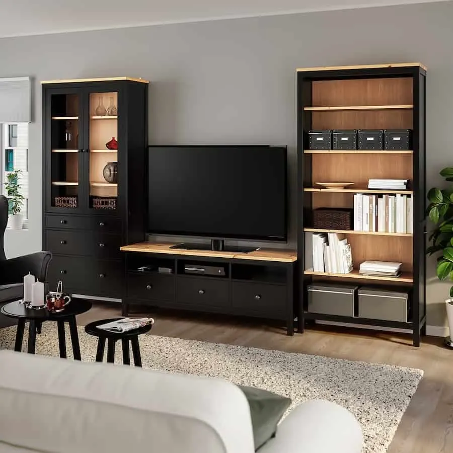 A complete living room with tv unit , cupboard and tv