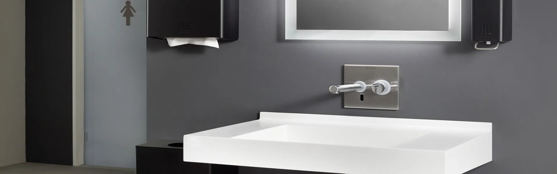 silver valve in a washroom with white washbasin