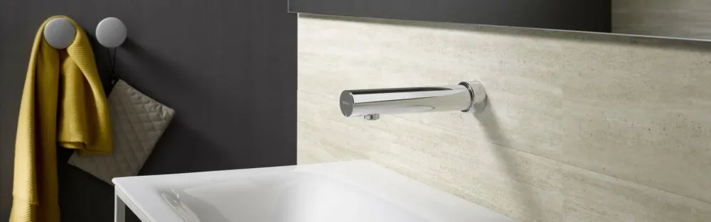 silver SCHELL sensor tap in a washroom with white washbasin