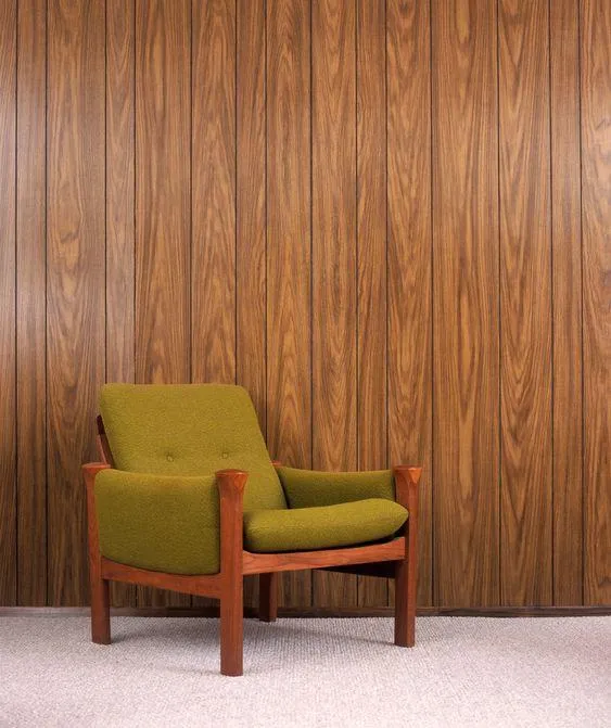 Wooden texture PVC wall panel with a green sofa in front