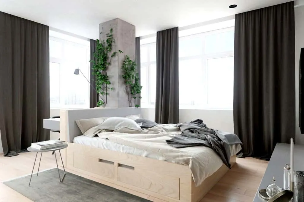 brown modern wood double bed design with storage in a bedroom with plants