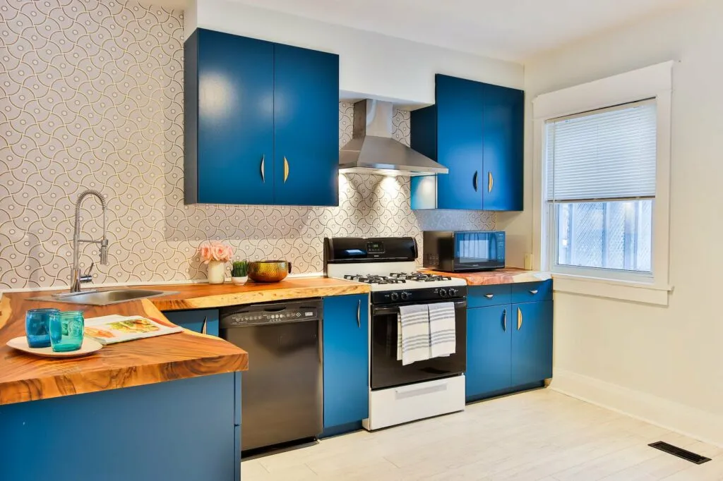 blue kitchen cabinets with beige backdrop is a trendy design in 2023