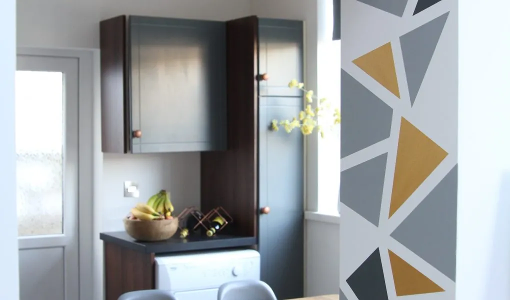 Kitchen wall with geometric design and cabinets