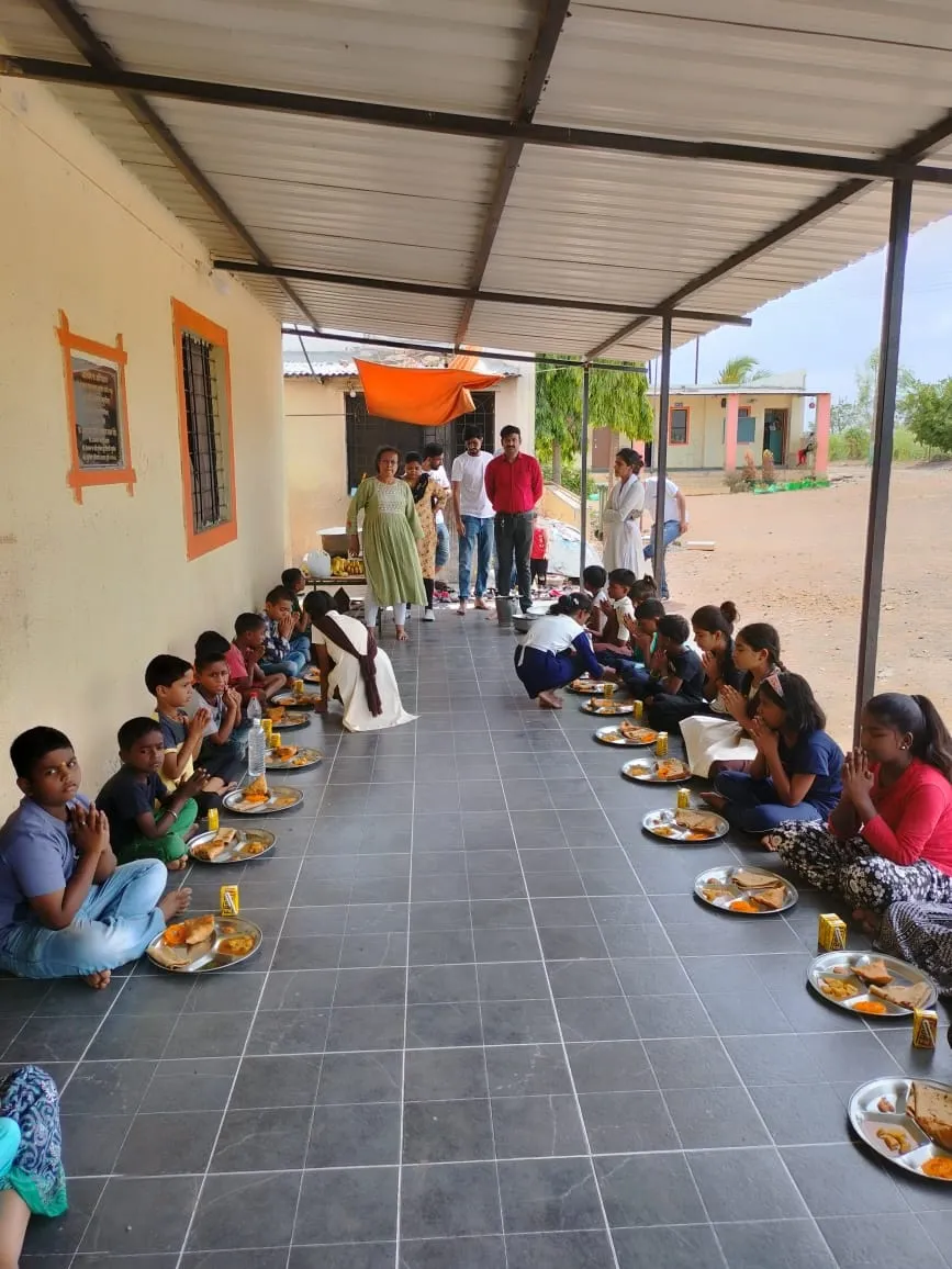 REHAU volunteers sharing lunch with children, CSR initiatives, Astitva Pratishthan