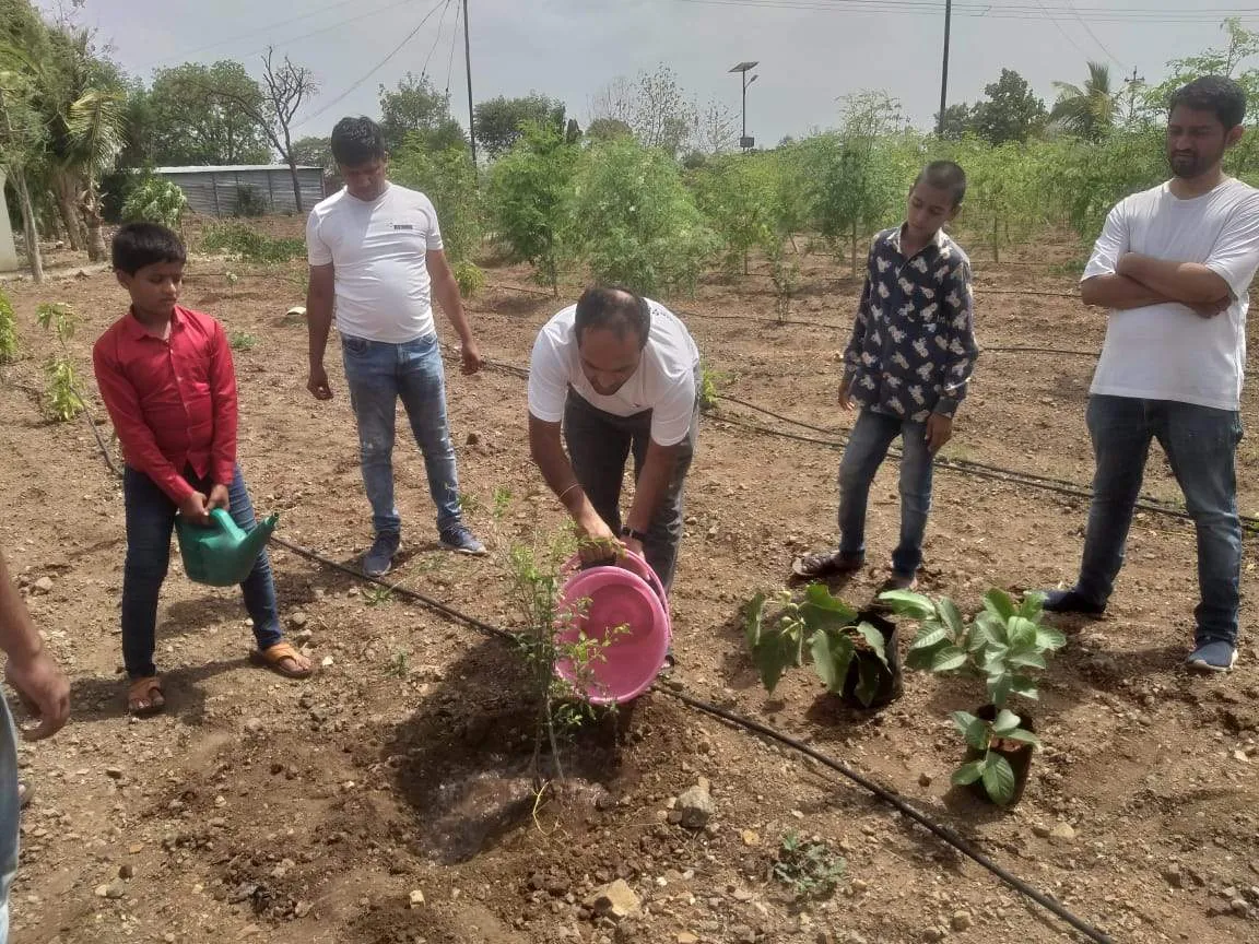 CSR initiative, REAHU volunteers planting with children