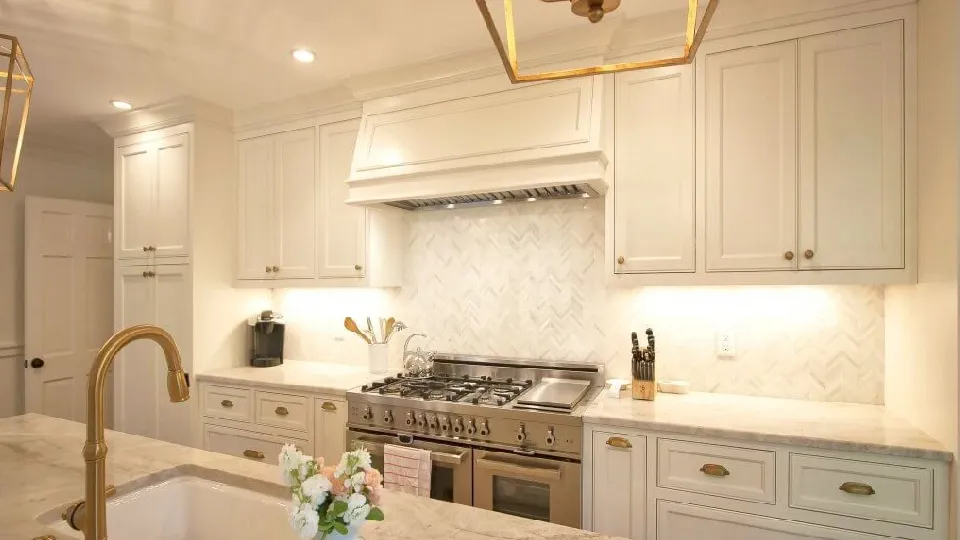 A kitchen with brass hardware, elegant luxury modern kitchen design
