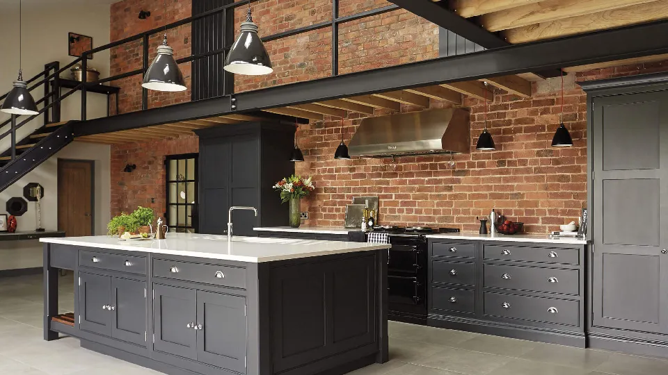A industrial style cooking space with pendant lights and vintage countertop