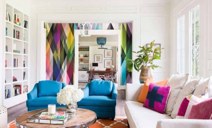 colourful room decor ideas for living room with blue sofa chairs and colourful throw pillows and brown rug