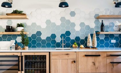 blue and white coloured hexagonal backsplash with wooden shelves and cabinetry