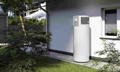 white sustainable domestic hot water heating pump system for outdoors in a house with a garden by Stiebel Eltron