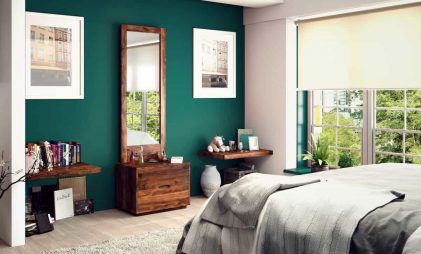 An exquisite wooden dressing table design with a rectangular mirror and minimum storage space, in a well-furnished green bedroom.