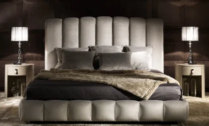 grey luxurious bed design with upholstered wood frame in a modern bed room with side table, table lamps and rug