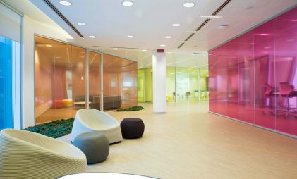 Different types of toughened or tempered glass in orange, pink and yellow in an office