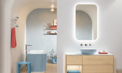 white bathroom with a mirror, washbasin, brown cabinet, blue bathtub,
