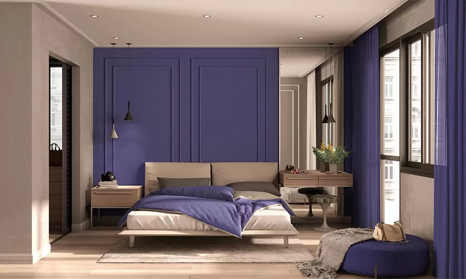 purple walls in a bedroom with bed, table and light