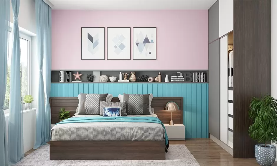 blue and pink bedroom with bed, table and lamp