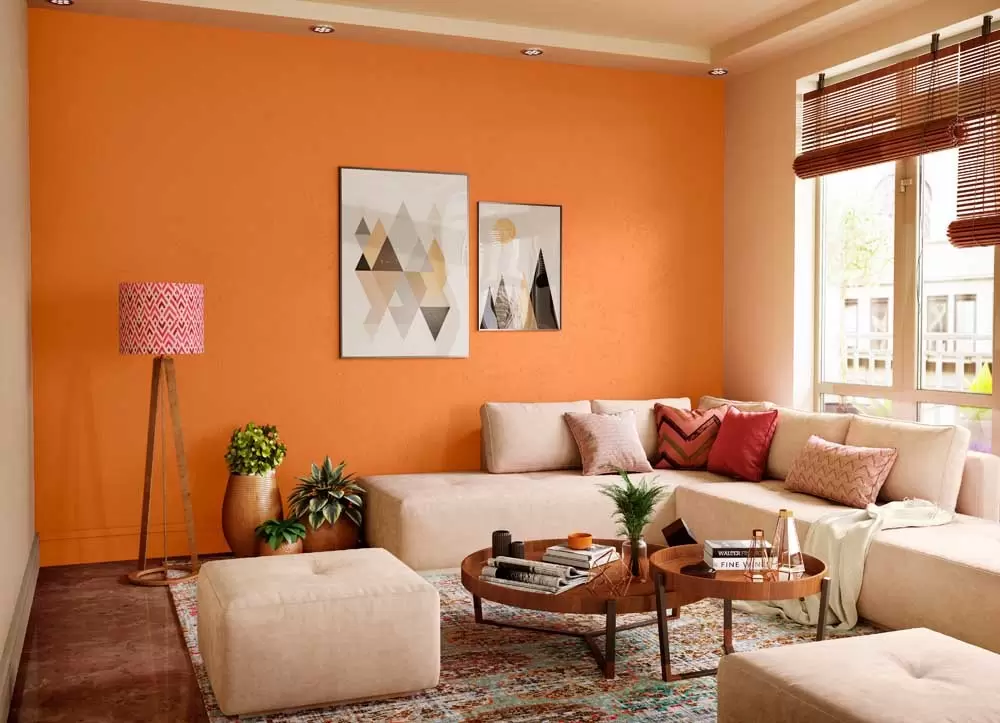 orange living room with beige sofa, table, plant