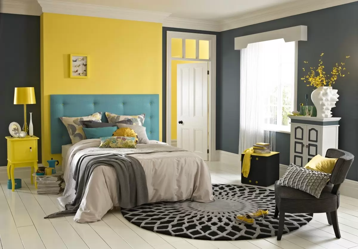 yellow and blue bedroom, bed, rug, chair, table
