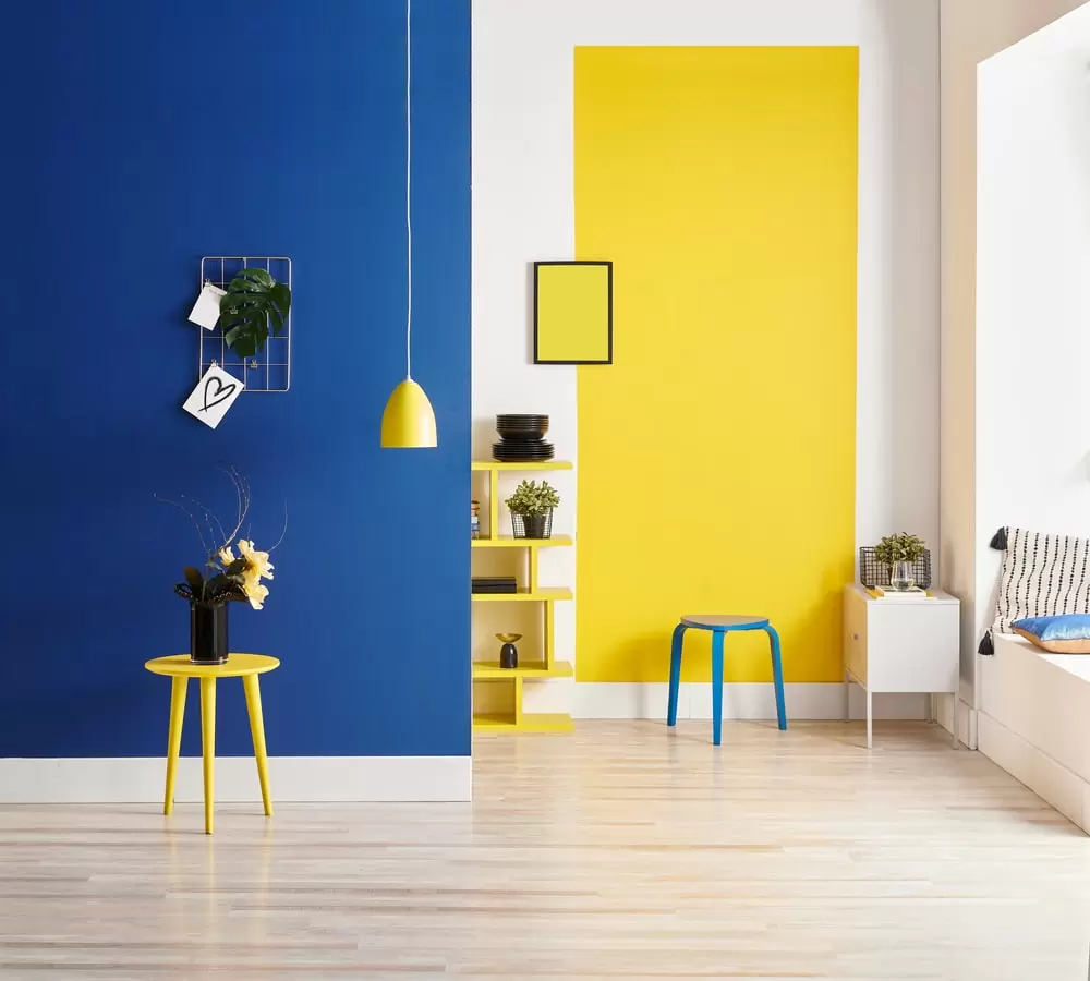 blue and yellow wall paint in a hall with table and lamp colour combination for bed room, living room, drawing room and hall walls