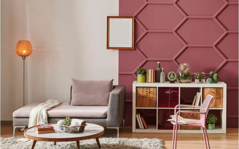 burgundy wall paint in a living room with sofa, table and shelf